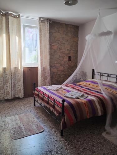 a bedroom with a bed with a canopy at Artemis House in Agios Nikolaos