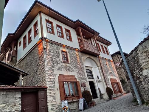 a building with a white and brown at Demirkapi Konak Hotel in Safranbolu