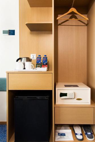 a kitchen with a stove and a microwave at Holiday Inn Express Macau City Centre by IHG in Macau