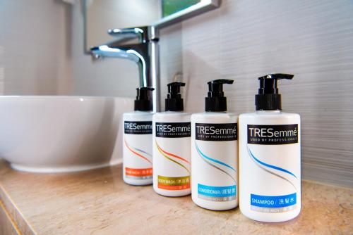 a group of three shampoo bottles sitting on a bathroom counter at Holiday Inn Express Macau City Centre by IHG in Macau