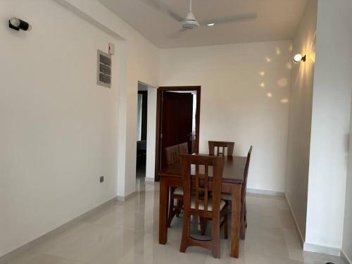 a dining room with a table and two chairs at Luxury 3 bed flat in Colombo 7 in Colombo