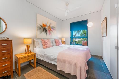 a bedroom with a bed and a dresser and a window at 10 Dash Apartment, Dunkirk in Sheffield Beach