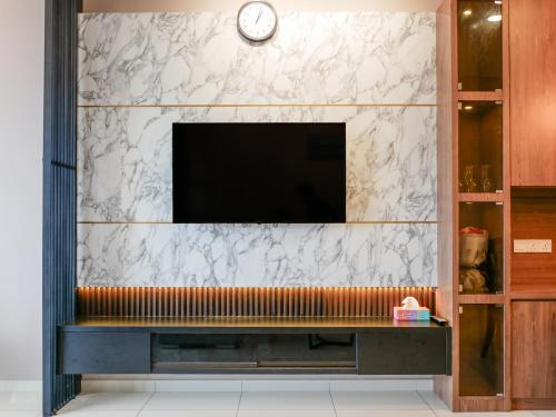 a living room with a television on a wall at Beacon Executive Suite by Uptrend Home Management in George Town