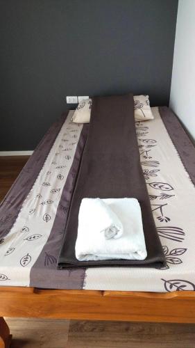 a bed with a blanket on top of it at New Loft Modern Home in Hang Dong