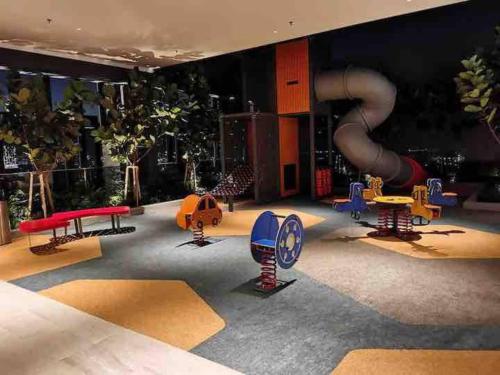 a room with a playground with a slide at Beacon Executive Suite by Uptrend Home Management in George Town