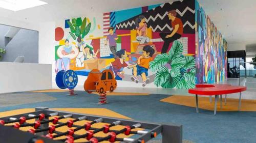 a room with a wall with a mural at Beacon Executive Suite by Uptrend Home Management in George Town