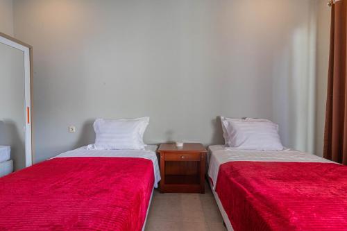 two beds sitting next to each other in a room at Villa Rose 1 Sanur in Sanur