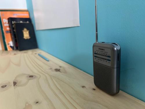 a modem sitting on a wooden table next to a book at East Harlem Hostel in New York