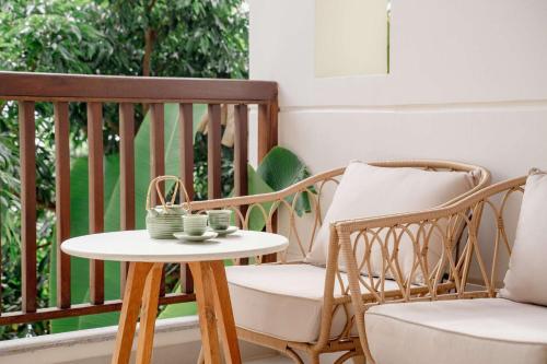 a table and a chair on a porch at Pax Ana Doc Let Resort & Spa in Ninh Hòa