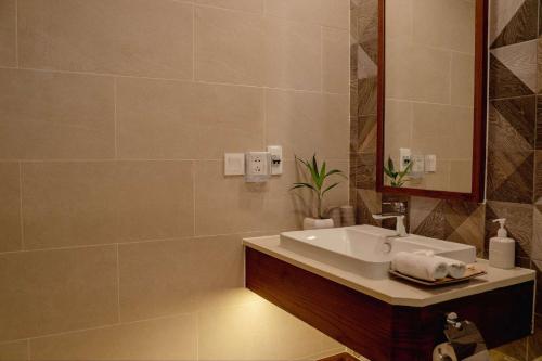 a bathroom with a sink and a mirror at Pax Ana Doc Let Resort & Spa in Ninh Hòa
