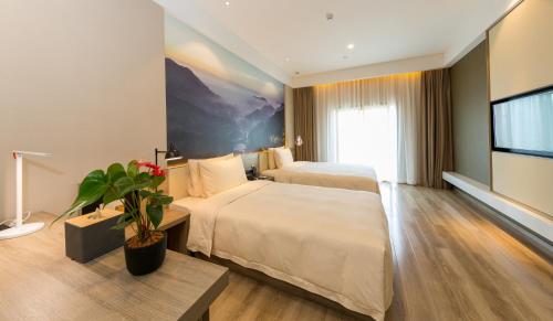 a hotel room with two beds and a flat screen tv at Atour Hotel Chongqing Hongyadong Riverview in Chongqing