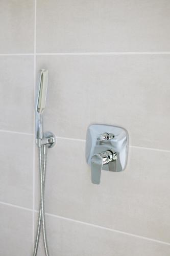 a bathroom with a shower head on a wall at La Roche Estate in Franschhoek