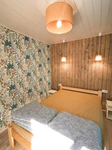a bedroom with a bed and a wall at Ostoja Stacze in Stacze