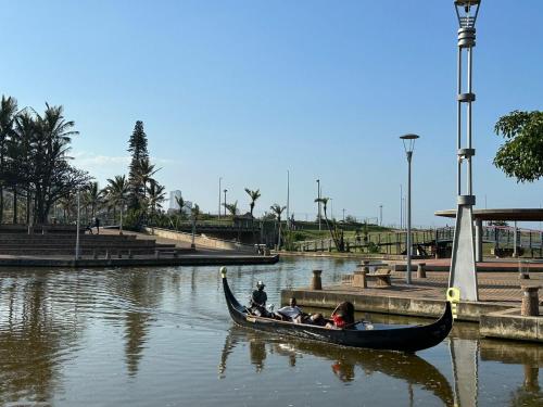 a group of people in a gondola on a river at DNA Dream Home in Durban