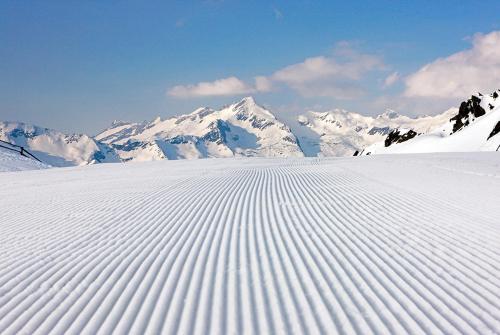 a snow covered mountain with mountains in the background at Pension Panorama in San Lorenzo di Sebato
