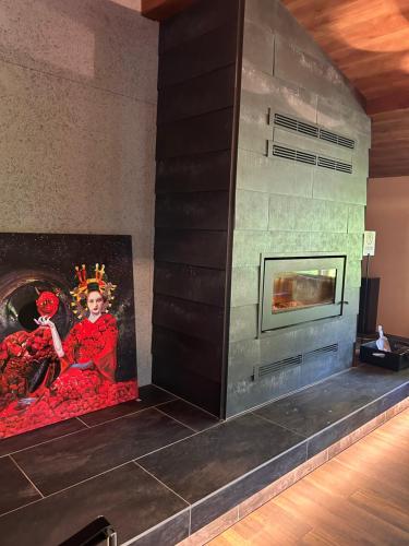a fireplace in a room with a painting on the wall at ユニテ蔵王ジョーニダ リゾート in Yamagata