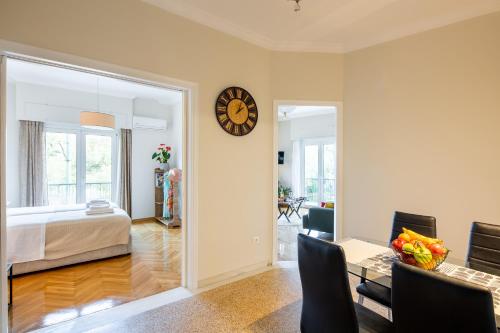 a bedroom with a bed and a clock on the wall at Renovated apartment near Acropolis in Athens