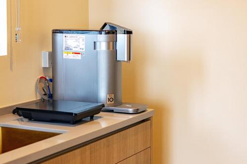 a coffee machine sitting on top of a counter at Urban Suites, Signature Collection by Stellar ALV in Jelutong