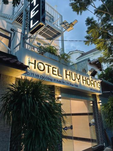 a hotel hilton sign on the side of a building at Huy Hoàng Hotel Phan Thiet in Phan Thiet