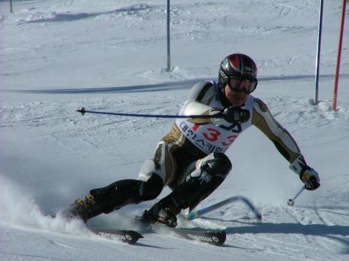 a man is skiing down a snow covered slope at White Cabin in Pyeongchang 
