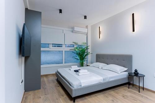 a bedroom with a bed and a large window at Luxury Downtown Apartment Α1 in Thessaloniki