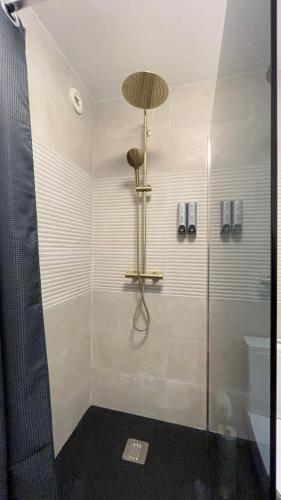 a shower with a glass door in a bathroom at Le Sainte Croix Hyper Centre Metz - parking gratuit in Metz