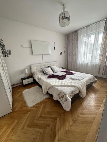 a bedroom with a bed and a wooden floor at central place in Braşov