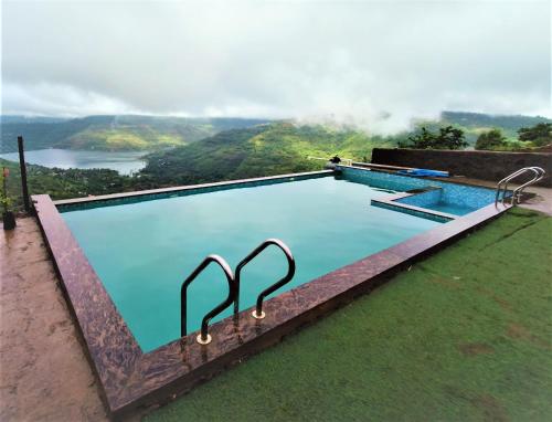a swimming pool with a view of a mountain at Vinayaka Holiday Homes - Infinity Pool and Breathtaking Valley View in Panchgani