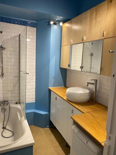 a bathroom with a sink and a bath tub at Kak's apartments Paris in Paris