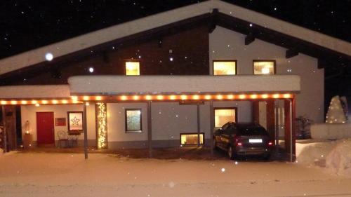 a car parked in front of a house with lights at Haus Christopherus in Klösterle am Arlberg