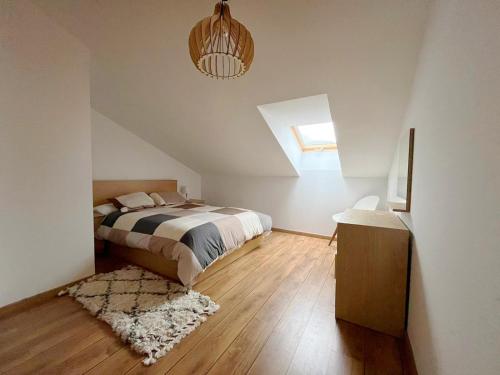 a bedroom with a bed and a skylight at El refugio de Porma. in Puebla de Lillo