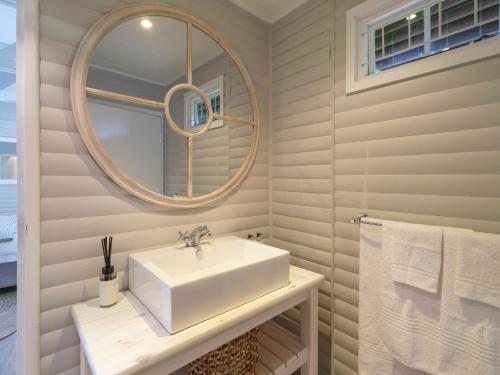 a white bathroom with a sink and a mirror at Sanddrif Stellenbosch Guest Farm in Stellenbosch