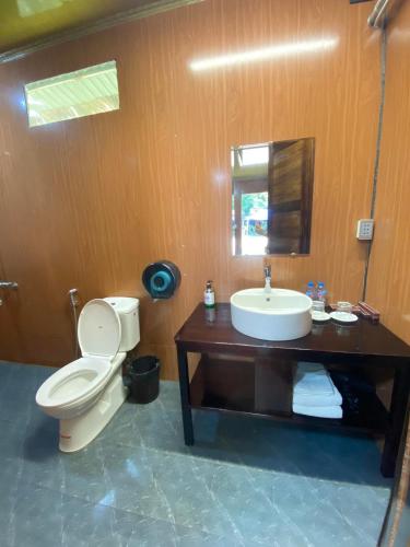 a bathroom with a toilet and a sink at Thai Hai Village - Bản làng Thái Hải 