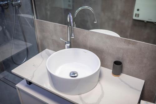 a bathroom with a white sink and a mirror at Widok 3B/6 in Piechowice
