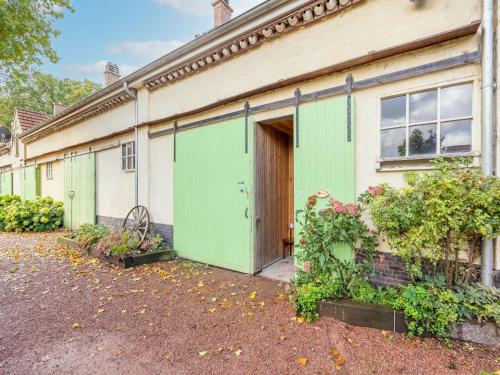 een oud huis met groene deuren en een oprit bij Nice apartment on UNESCO World Heritage Site Wortel Kolonie 