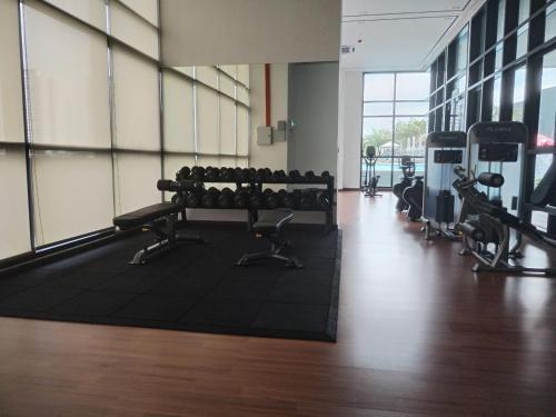 a gym with a row of benches with weights at Japandi Family Play Suite with Slide Bunk Bed in Kajang