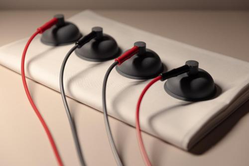 a cake with three black and red wires on it at Boutique Hotel Saxonia in Karlovy Vary