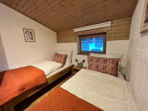 a small room with two beds and a tv at Hanna's Home in Kitzbühel