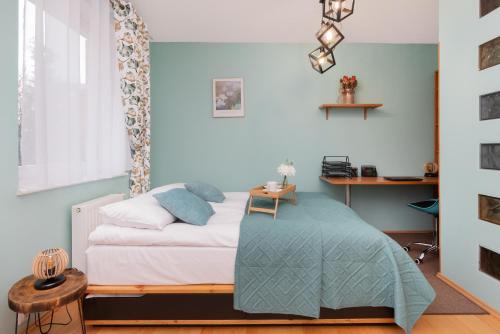 a bedroom with a bed with a table on it at Subtle and Cosy Studio with Furnished Balcony in Gdańsk by Renters in Gdańsk