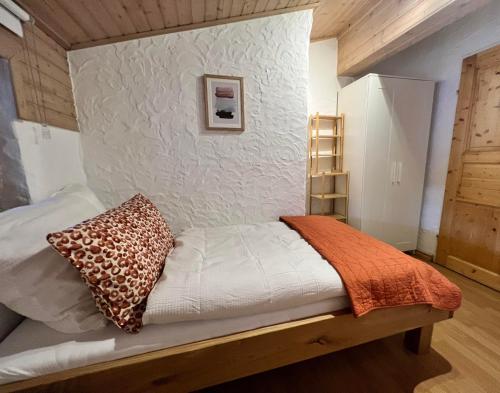 a bed in a room with a wall at Hanna's Home in Kitzbühel