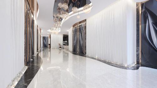 a hallway with a marble floor and a chandelier at Royal M Al Aqah Beach Resort by Gewan in Al Aqah