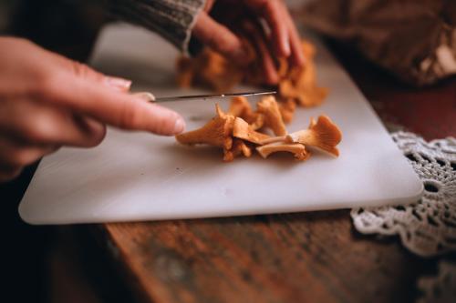 a person cutting up a pile of stars on a cutting board at Kalix Riverside inn in Kalix