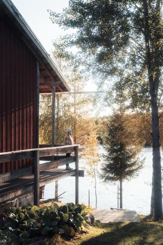 a person standing on a dock next to a house at Kalix Riverside inn in Kalix