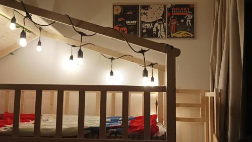 a bedroom with a crib with lights on it at Japandi Family Play Suite with Slide Bunk Bed in Kajang