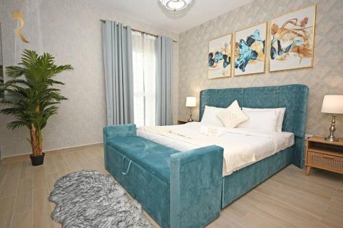 a bedroom with a large bed with a blue couch at Yas Island 2 BR Turquoise in Abu Dhabi