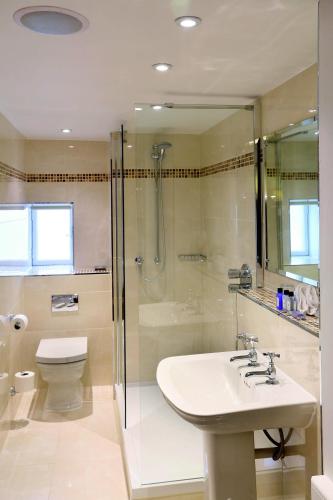 a bathroom with a sink and a shower and a toilet at Macdonald Houstoun House in Livingston