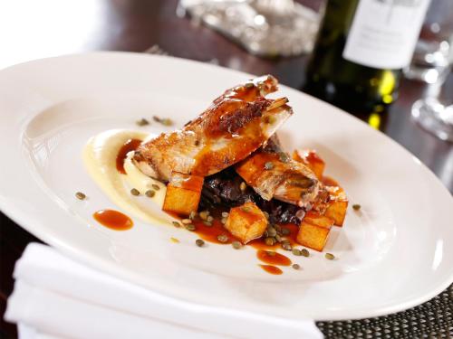 a white plate with some food on a table at Macdonald Houstoun House in Livingston