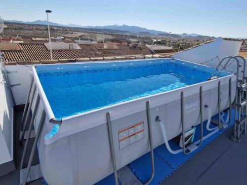 a swimming pool on the roof of a building at Villa Rose in Camposol