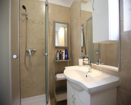 a bathroom with a sink and a shower at Romantic stone villa with pool, panoramic sea view near the beach - by Traveler tourist agency Krk ID 2134 in Vrbnik