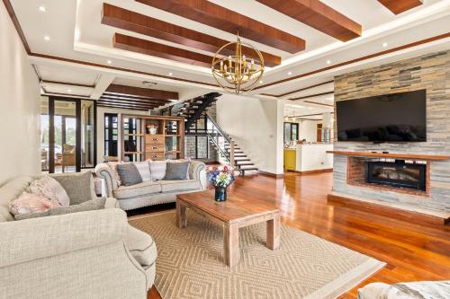 a living room with two couches and a fireplace at Kirimara Woodlands, Nanyuki in Nanyuki